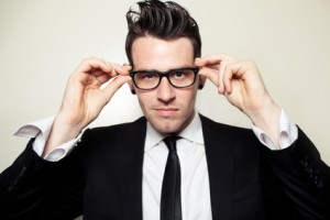 Young Businessman holding black glasses